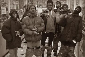Group of young men posing in a store with serious expressions.