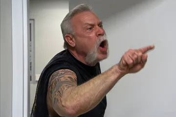 Two men in a heated argument in an office setting.