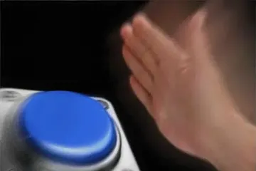 A hand slamming a large blue button with motion blur.