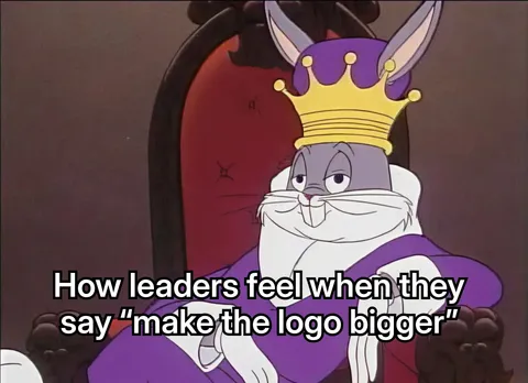 Bugs Bunny wearing a crown and royal robe, sitting on a throne.