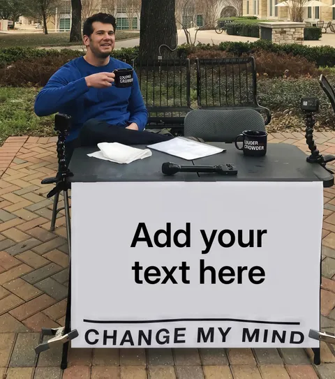 Steven Crowder sitting at a table with a blank sign that says 'Change My Mind'.