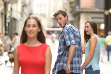 Man looking at another woman while his girlfriend looks shocked.