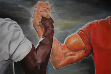 Two muscular arms in a handshake from the Epic Handshake meme.