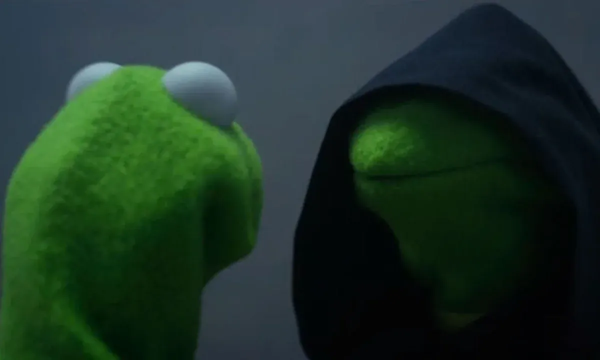 Kermit the Frog facing his evil doppelgänger in a dark hood.