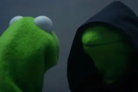 Kermit the Frog facing his evil doppelgänger in a dark hood.