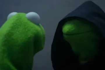 Kermit the Frog facing his evil doppelgänger in a dark hood.
