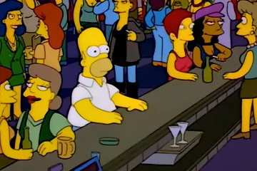 Homer Simpson sitting alone at a crowded bar from The Simpsons.