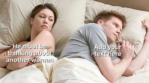 A woman and man lying in bed, woman looking suspiciously at the man.