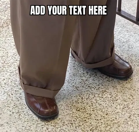 Close-up of oversized brown pants and shoes on a tiled floor.