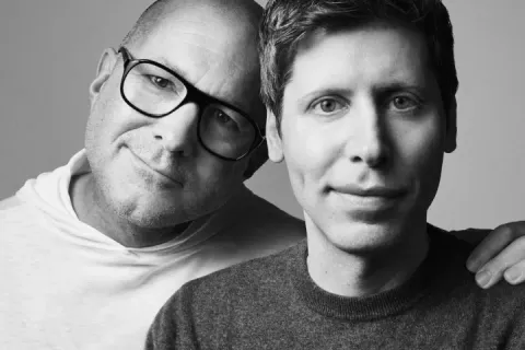 Jony Ive and Sam Altman posing together in a black and white photo.