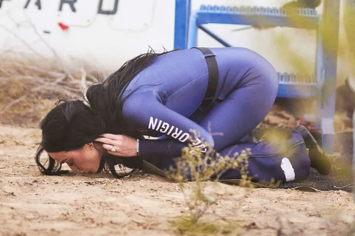 Katy Perry kissing the ground after a Blue Origin space flight.