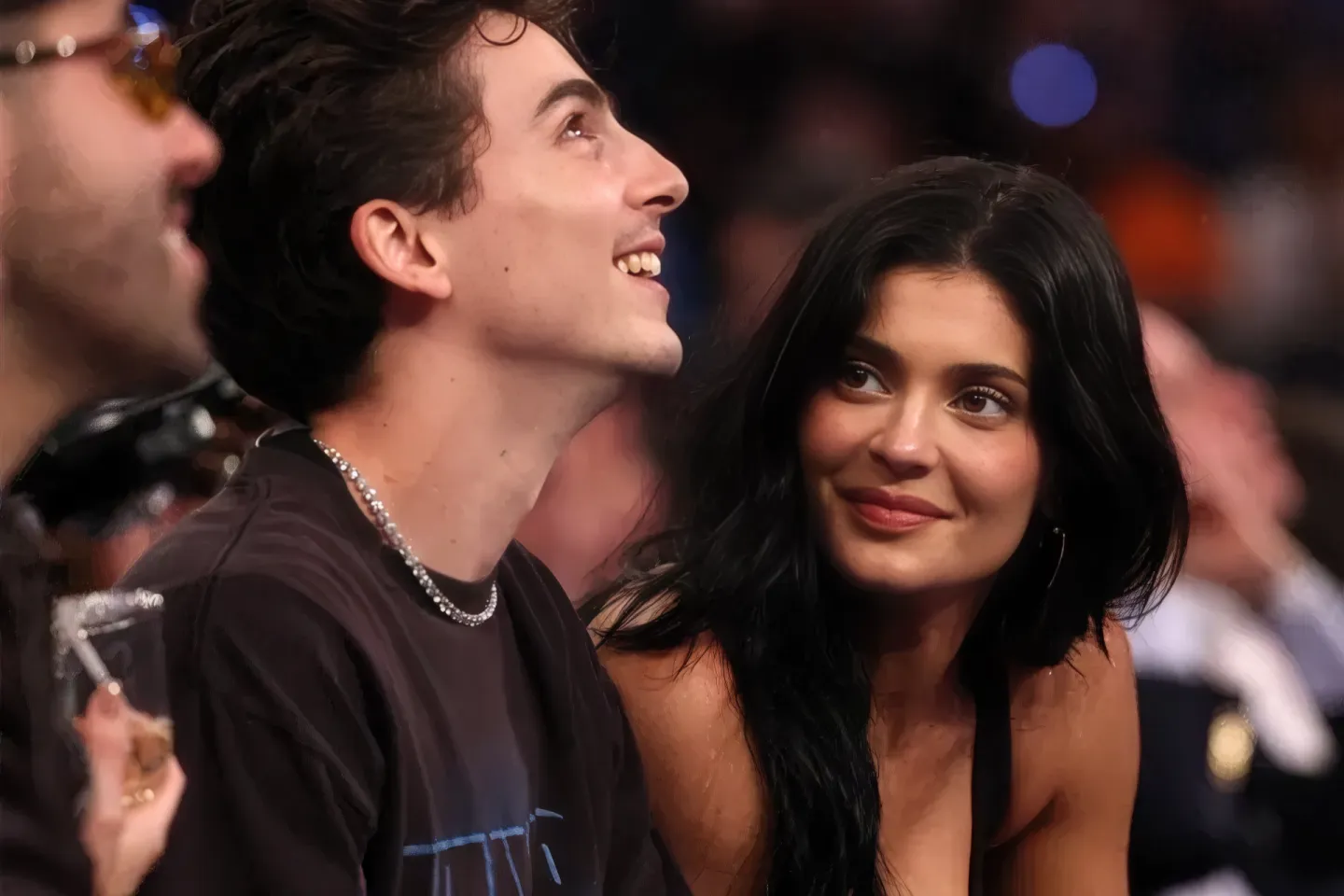 Kylie Jenner gazing at Timothée Chalamet during a basketball game.