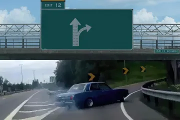 Car skidding onto a highway exit ramp with a road sign overhead.