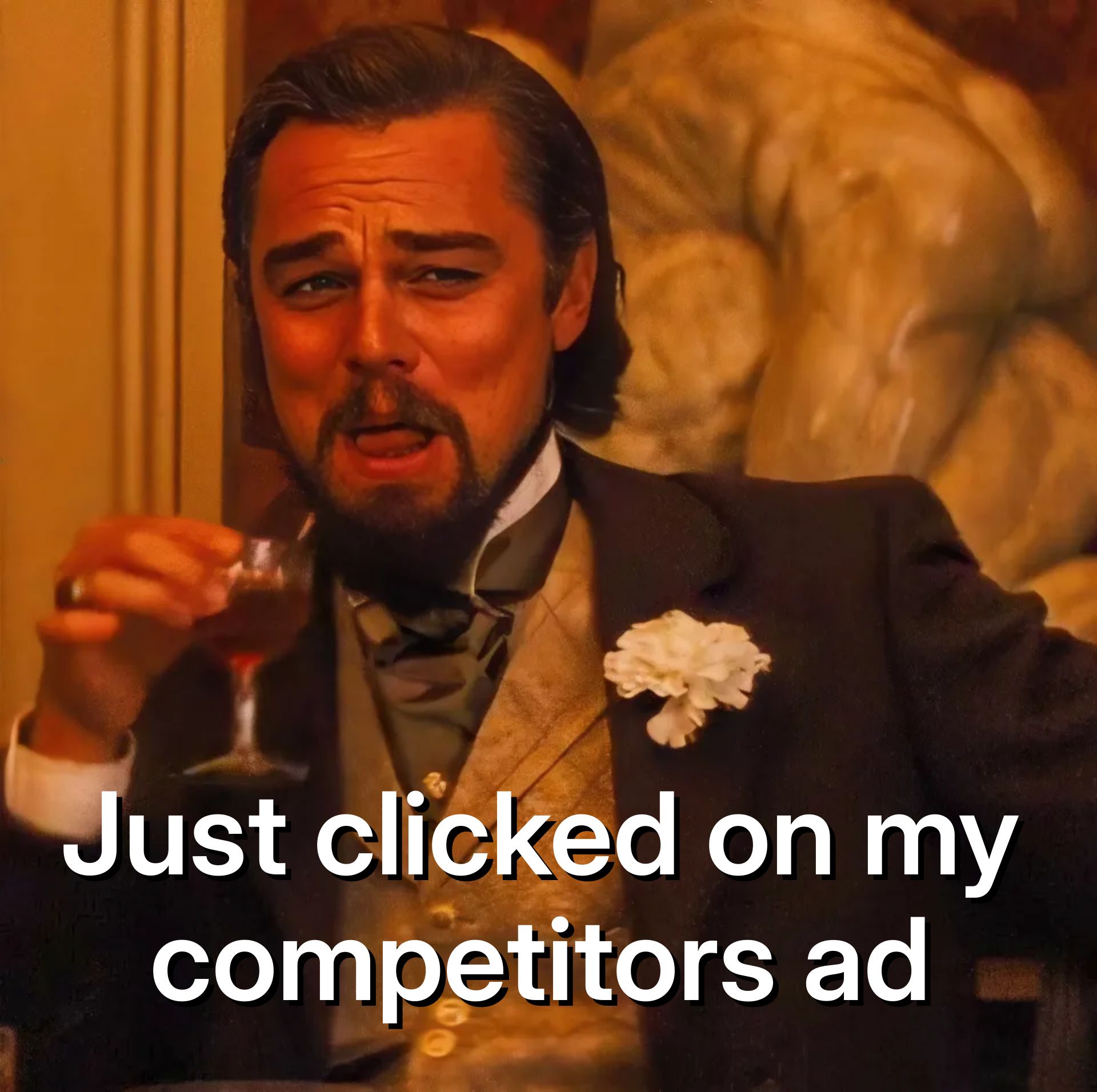 Leonardo DiCaprio in a suit holding a drink, laughing with a scrunched face.