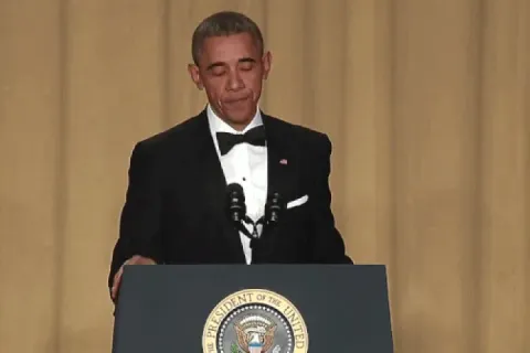 Barack Obama performing a mic drop at a podium.