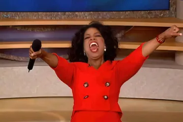 Oprah Winfrey enthusiastically giving away gifts on her show.