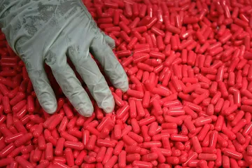 Two pills, one red and one blue, symbolizing a choice.