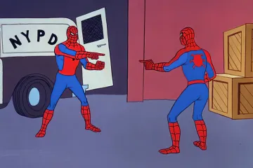 Two Spiderman characters pointing at each other in a warehouse setting.