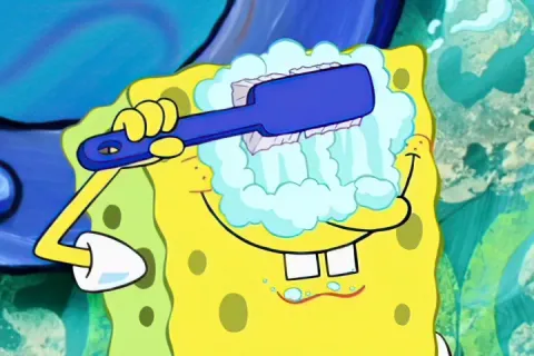 SpongeBob SquarePants brushing his eyes with a toothbrush and soap bubbles.