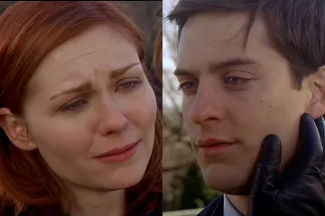 A woman crying while talking to a man in a dramatic scene from a movie.