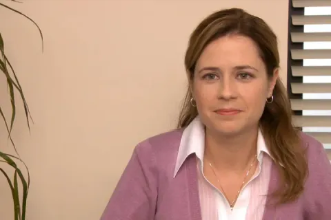 Scene from The Office with Pam holding two identical sheets of paper.