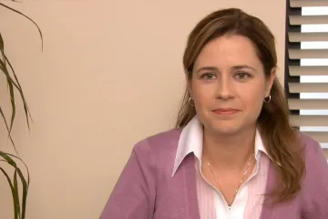 Scene from The Office with Pam holding two identical sheets of paper.