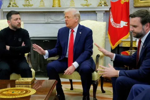 Donald Trump gesturing to Volodymyr Zelensky in a meeting setting.