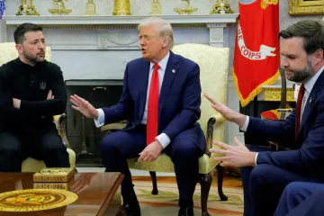 Donald Trump gesturing to Volodymyr Zelensky in a meeting setting.