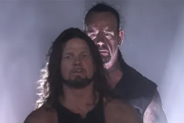 Two wrestlers in a dramatic, misty setting with intense expressions.
