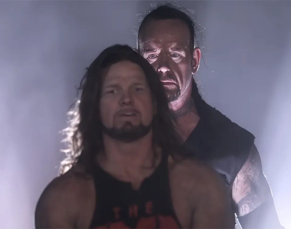 Two wrestlers in a dramatic, misty setting with intense expressions.
