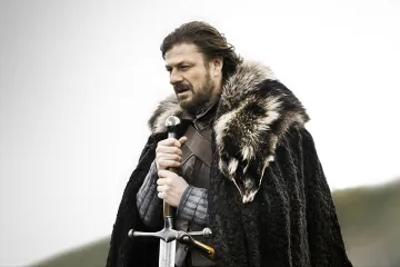 Ned Stark from Game of Thrones holding a sword, wearing a fur cloak.